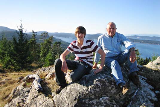 Bill Anders and Glen Keough seated on a hill